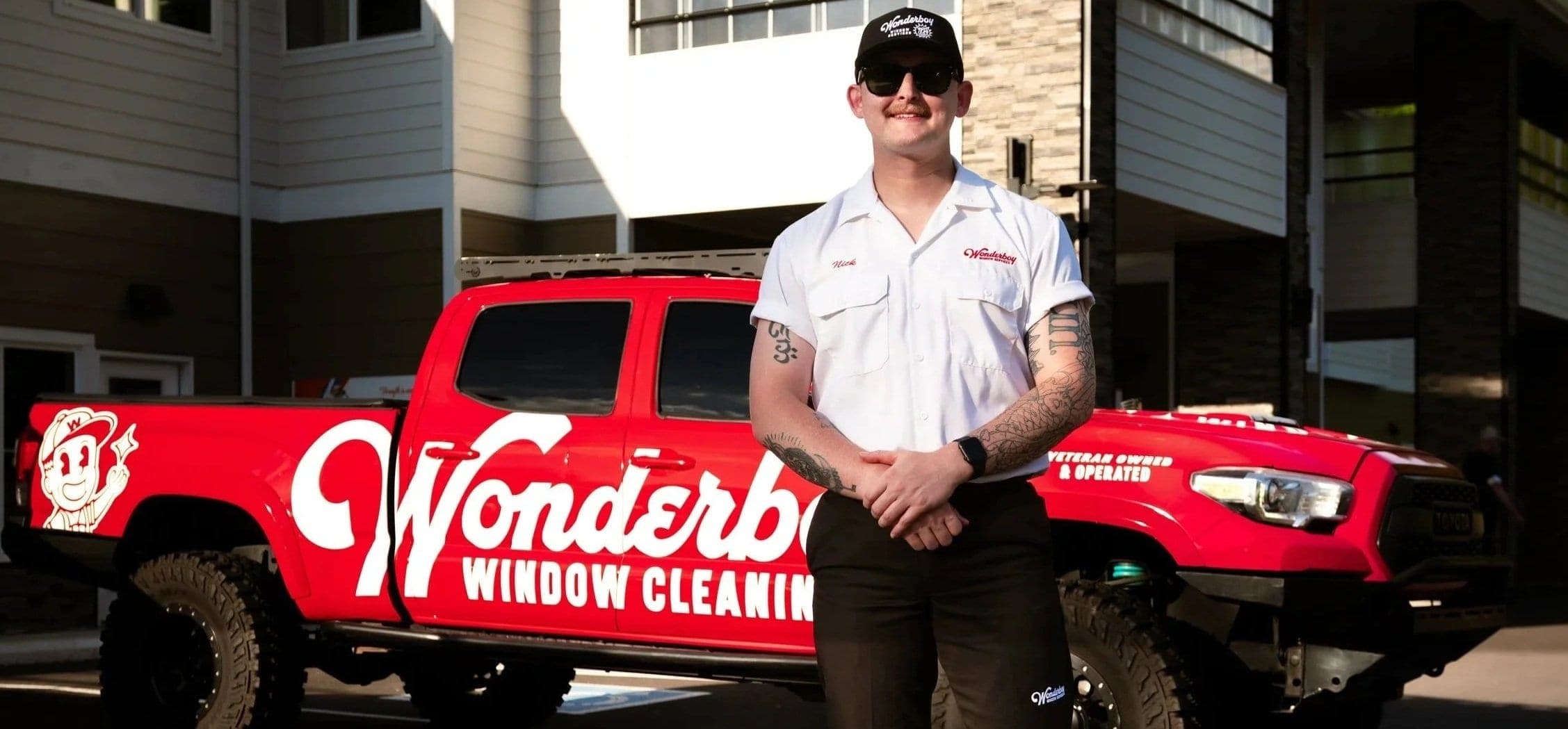 Wonderboy window cleaner standing in front of the red Wonderboy truck